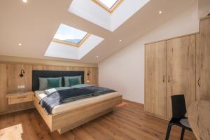 a bedroom with a bed and a skylight at Balbeinhof Apt Gams in Luson