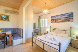 a bedroom with a bed and a table and a desk at Captain Spiros Picola in Gaios