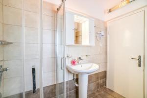 a bathroom with a sink and a shower at Captain Spiros Picola in Gaios