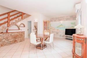 a living room with a table and a tv at Villa Alfredo Golfo Aranci in Golfo Aranci