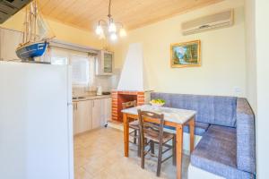 a living room with a table and a blue couch at Captain Spiros Picola in Gaios +19 photos