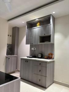 a kitchen with stainless steel cabinets in a room at The Bloomhouse inn in Rājpur