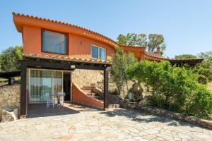 a house with a patio in front of it at Harmònia Residence in Villasimius