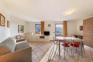a living room with a couch and a table at Apartment Litegosa - Casa Alma in Tesero