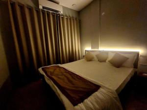 a bedroom with a bed with a light on it at Twilight Stays ll 2 Bed Villa ll Swimming Pool ll AC ll BBQ in Lonavala