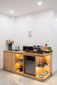 a wooden counter with shoes in a room at 2Re Hidden Hostel 58 Hàng Bạc in Hanoi