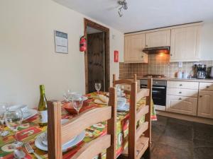 a kitchen with a table with wine glasses on it at Cider Cottage - near Lyme Regis in Axminster