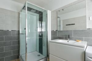 a bathroom with a glass shower and a sink at Gite Les Salicornes in Lanchères +14 photos