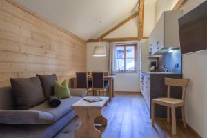 a living room with a couch and a kitchen at Appartement Moosmann in Mellau