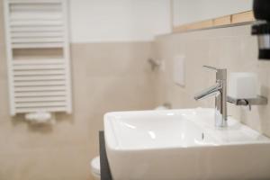 a bathroom with a sink and a faucet at Natur Suite Edelweisshof App Heidi in Chiusa