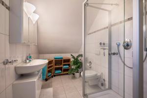 a bathroom with a sink and a toilet and a shower at Ferienwohnung 1 Soltau in Soltau +10 photos
