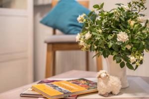 a toy dog sitting on a table next to a book at Ferienwohnung 1 Soltau in Soltau