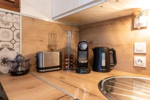 a kitchen counter with a coffee maker and a blender at Appartement Les Cezares in Les Allues