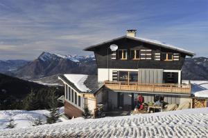 a house sitting on top of a snow covered mountain at Chalet d' Egloo 10-12 pers in Samoëns