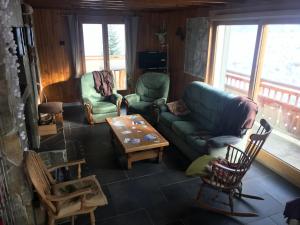 a living room with a couch and chairs and a table at Chalet d' Egloo 10-12 pers in Samoëns