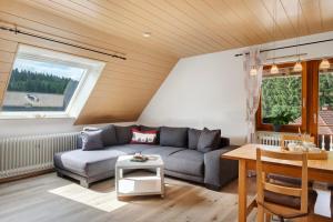 a living room with a couch and a table at Ferienwohnung Ringwald in Niederbach