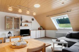 a living room with a table and a couch at Ferienwohnung Ringwald in Niederbach