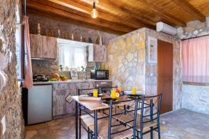 a kitchen with a table and chairs in a room at Villa Lazar in Lefkada +31 photos
