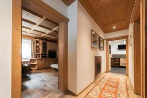 an open hallway with a fireplace in a house at Ciasa Ilda - Charming House 120 M2 in La Valle