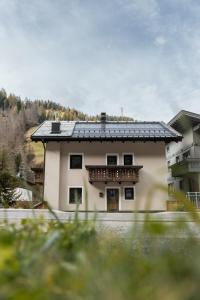 a building with a balcony on the side of it at Ciasa Ilda - Charming House 120 M2 in La Valle