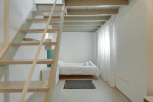 a room with a ladder leading up to a bunk bed at Serenity in Arona
