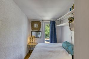 a bedroom with a bed and a window at Designer House With Panoramic views in Cadaqués