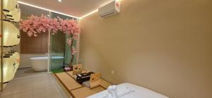 a bedroom with a bathroom with a tub and a sink at Ipoh Town Hotel by Serenity in Ipoh
