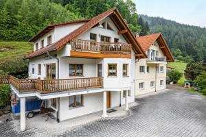 an apartment building with a balcony and a driveway at Haus Sum in Oberwolfach