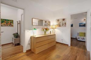 a room with a dresser with a vase of flowers on it at Appartamenti in Agriturismo in Fisciano