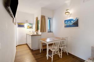 a kitchen and dining room with a table and chairs at Appartamenti in Agriturismo in Fisciano +19 photos