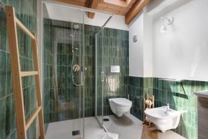 a bathroom with a shower and a toilet and a sink at Appartamenti in Agriturismo in Fisciano