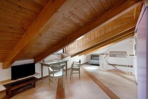 a room with a table and a tv and a staircase at Appartamenti in Agriturismo in Fisciano