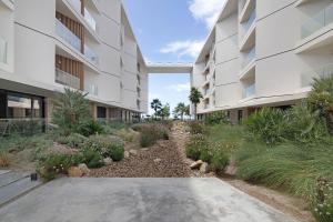 an external view of an apartment building with a garden at Mare Nostrum in Olhão