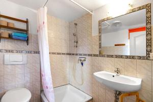 a bathroom with a sink and a toilet at Apartment Eulenhof 1 in Bordelum