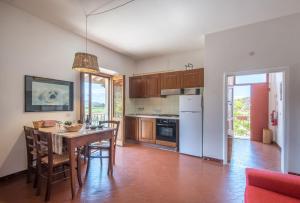 a kitchen with a table and a dining room at Podere del Pereto Bio- 201 in Rapolano Terme