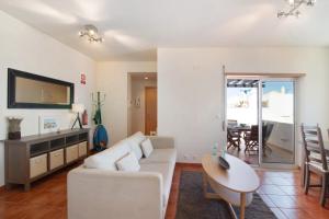 a living room with a couch and a table at Quinta Gomeira 146 in Cabanas de Tavira