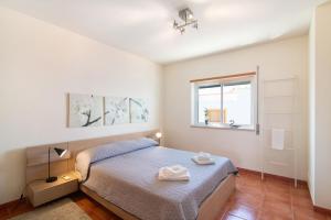 a bedroom with a bed and a window at Quinta Gomeira 146 in Cabanas de Tavira