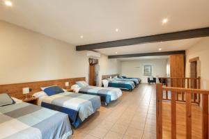 a row of four beds in a room at Cal Cirera in Sagás +36 photos
