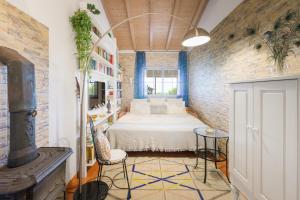 a bedroom with a bed and a brick wall at Sítio das Rolas - Selão da Eira in São Teotónio +37 photos