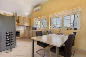 a kitchen with a dining room table and chairs at Gästesuite mit Sauna in Kehl am Rhein