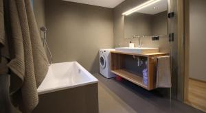 a bathroom with a sink and a washing machine at Bergchalet Prantach in San Martino +37 photos
