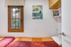 a bedroom with a bed and a window at Set Cases in L'Escala +22 photos