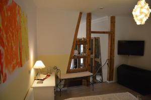 a living room with a chair and a television at Ferienwohnung Harz Idylle in Güntersberge