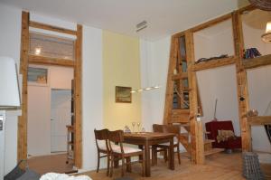a kitchen and dining room with a table and chairs at Ferienwohnung Harz Idylle in Güntersberge +13 photos