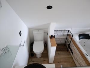 a bathroom with a toilet in a small room at " Al'Coppette " Gîte open-space in Comblain-au-Pont