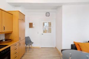 a small kitchen with a white door and a chair at Vogelsberger Bett 5 die 1 in Alsfeld +9 photos