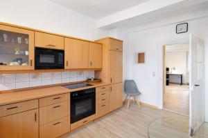 a kitchen with wooden cabinets and a table and a chair at Vogelsberger Bett 5 die 1 in Alsfeld