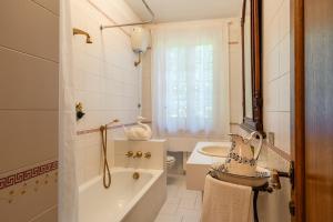 a bathroom with a tub and a toilet and a sink at Casa Spazio Zero in Cantagrillo +14 photos