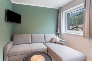 a living room with a couch and a window at Luisalle Top 1 in Auffach