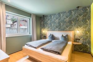 a bedroom with a bed and a wall mural at Luisalle Top 1 in Auffach